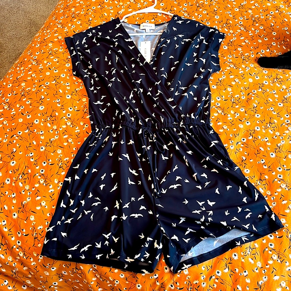 Black romper woth birds on it